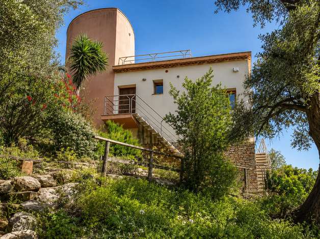 Exterior of the Begur house among pines