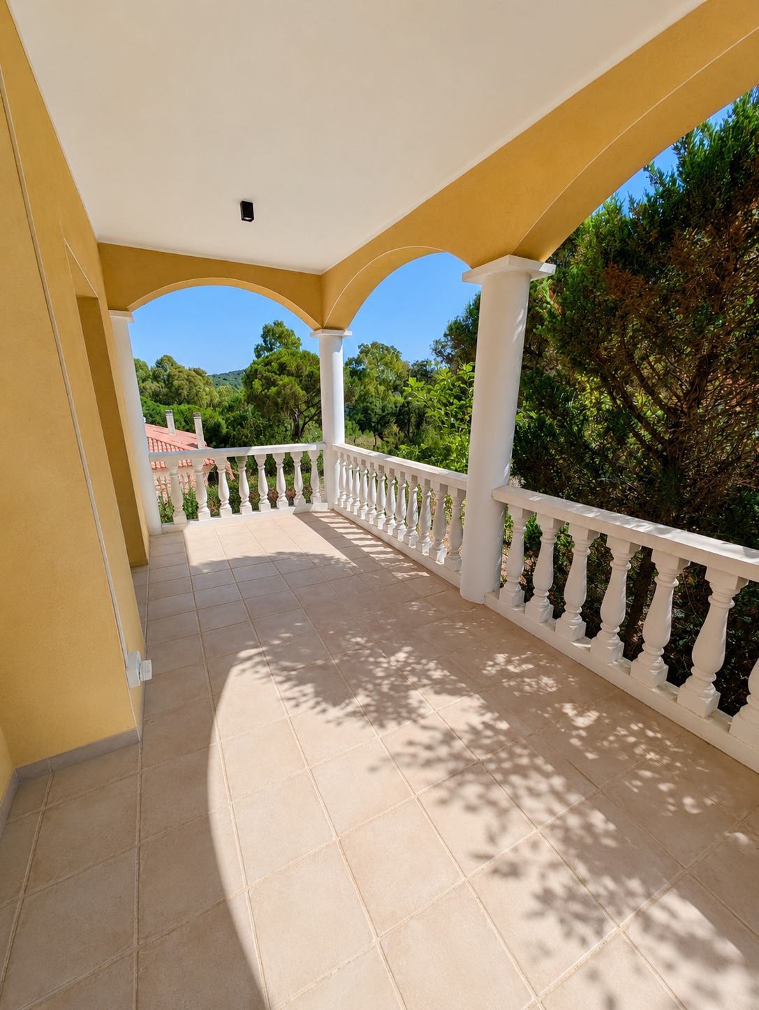Covered arched terrace with garden views